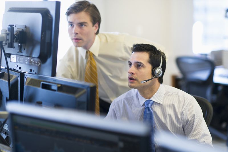 USA, New York, New York City, Traders at Trading Desk