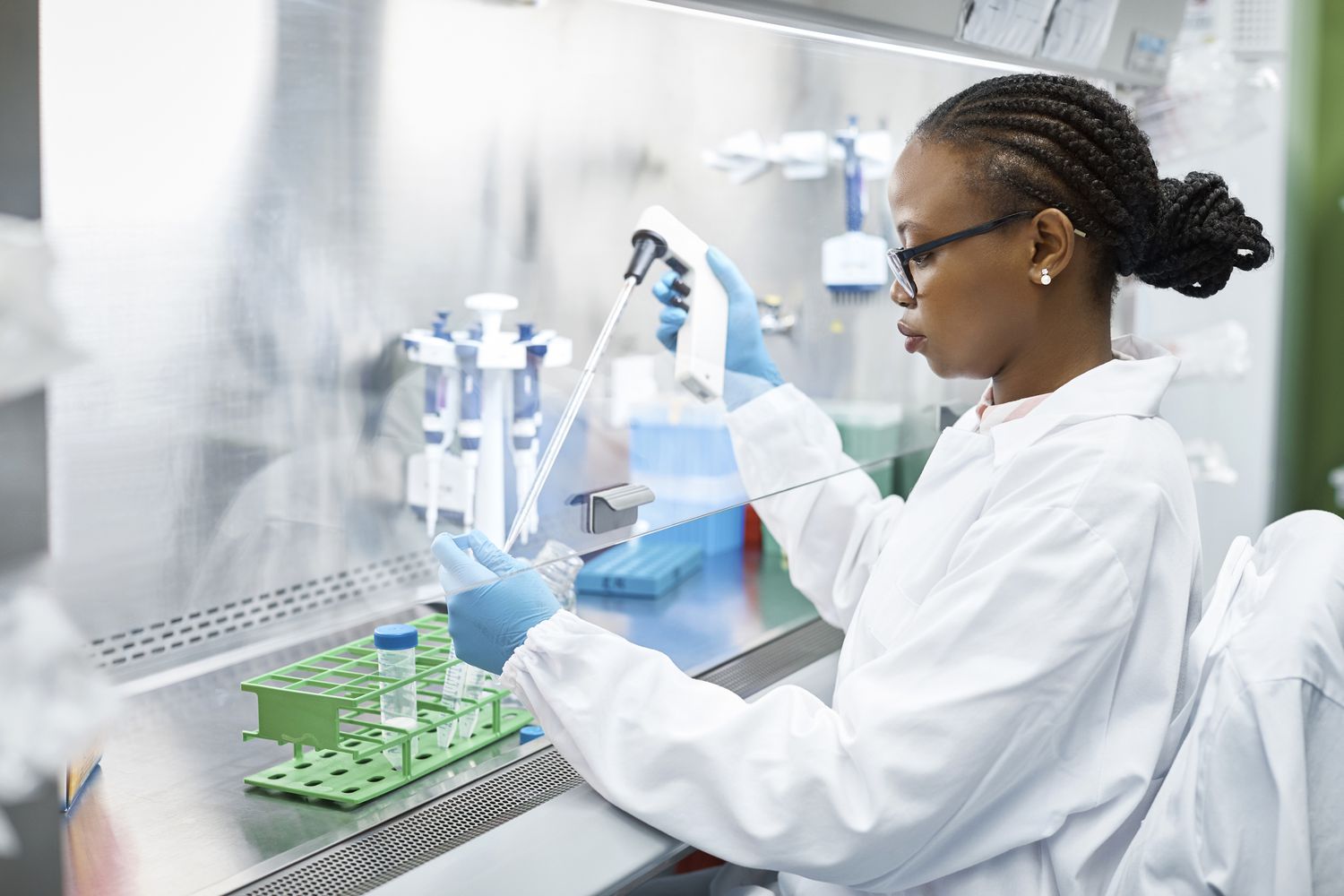 Scientist in lab coat analyzing a medical sample in laboratory