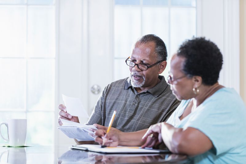 A couple sitting at a table review documents.