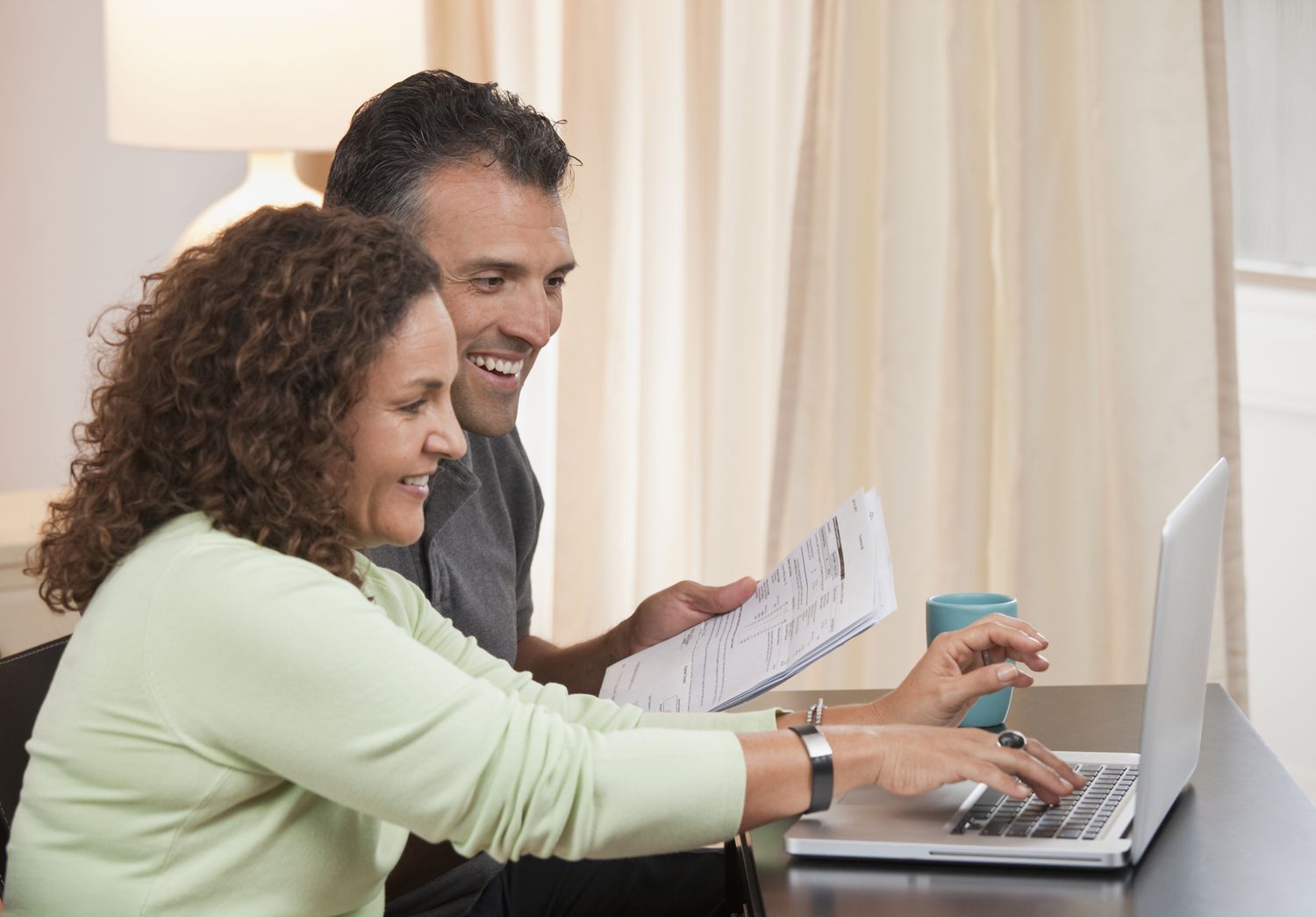 Couple paying taxes with laptop