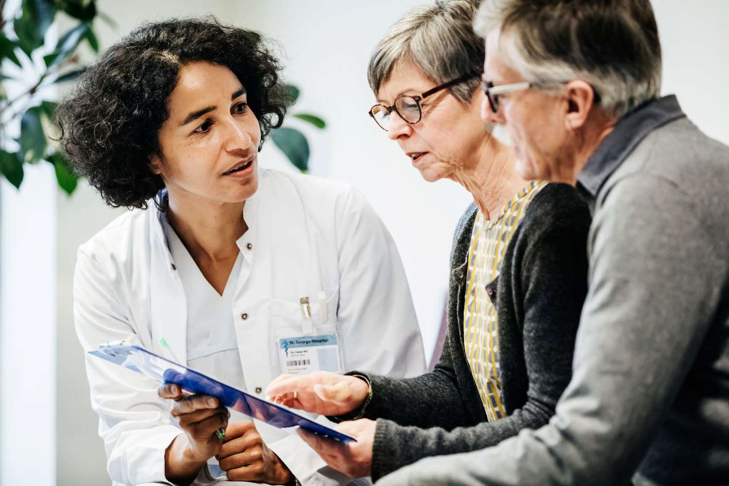 A doctor speaking with older couple
