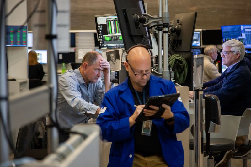 Traders work on the floor in the American Stock Exchange area of the New York Stock Exchange