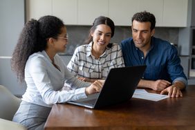 Couple speaking to a financial advisor about finances.