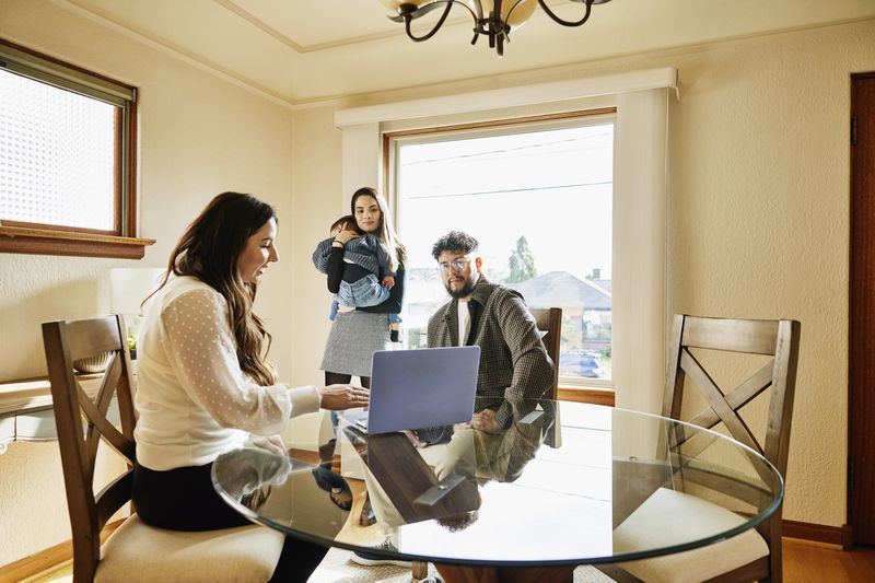 Homeowner talking to a couple about renting a room in their two-family house