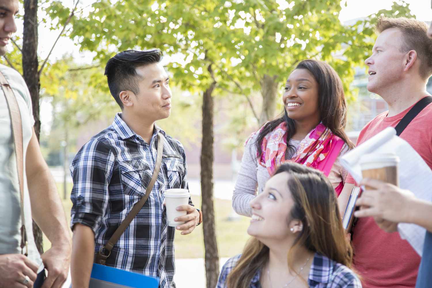 Student with friends wondering whether college tuition or investing is a better use of his money 