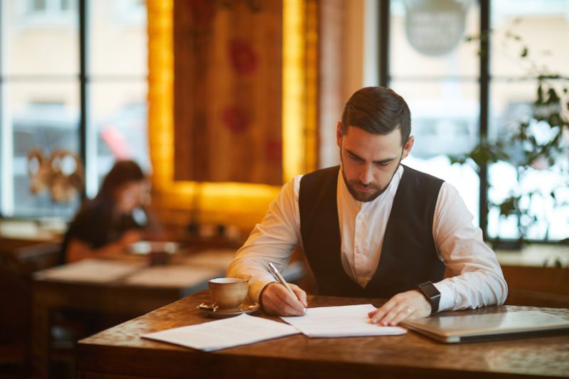 A worker at a table in a cafe 