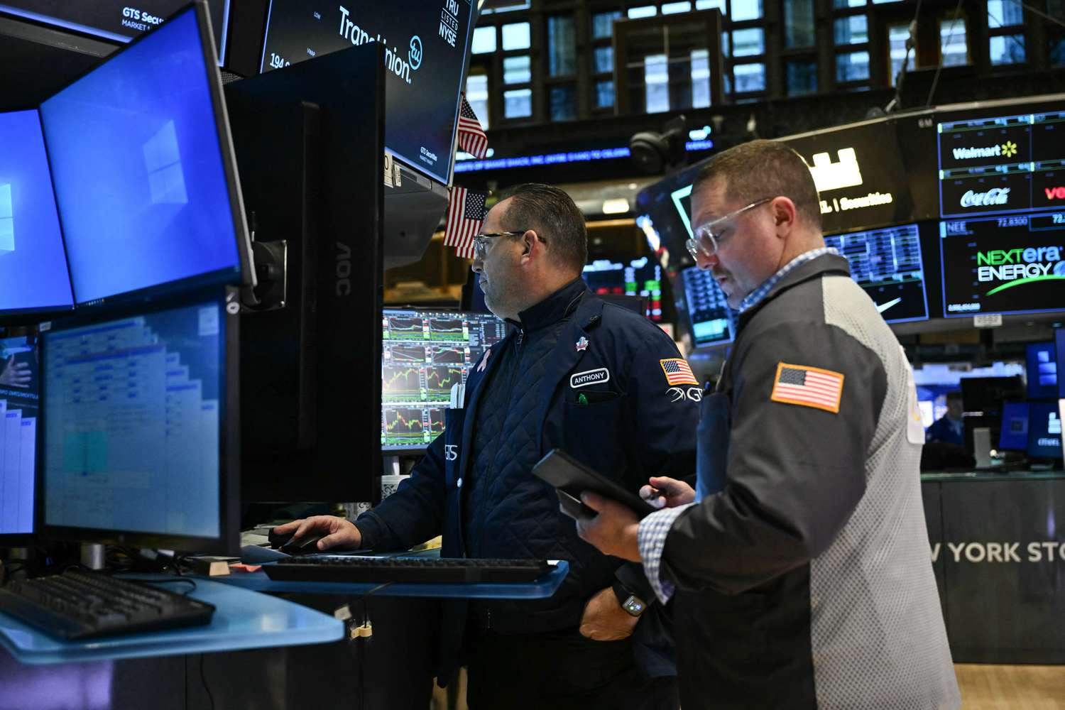Traders and financial professionals work on the floor of the New York Stock Exchange 