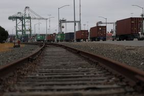 Trucks line up to enter a shipping berth at the Port of Oakland on April 18, 2025 in Oakland, California.