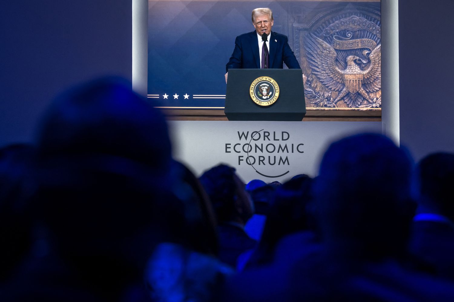 US President Donald Trump is seen on a large screen during his address by video conference at the World Economic Forum (WEF) annual meeting in Davos on January 23, 2025. 
