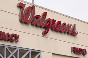 The red Walgreens logo is seen on the side of a building.