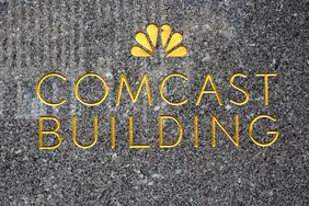 Logo embellishes a granite wall near the entrance to the Comcast Building in New York.