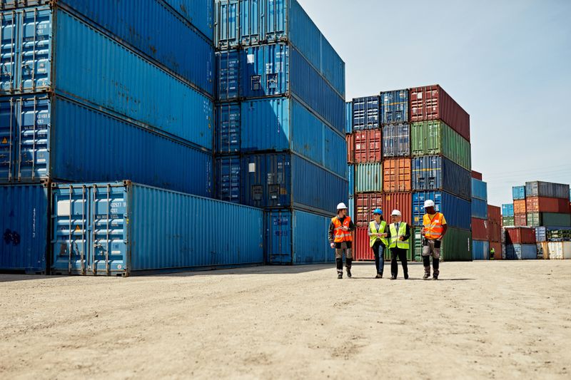 Workers with shipping containers