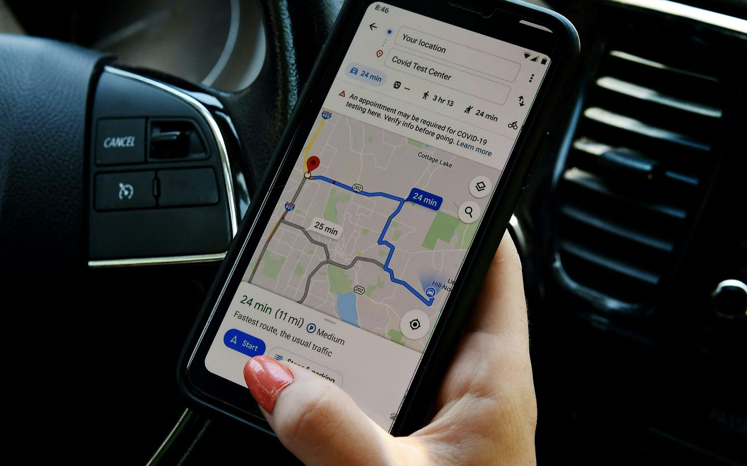 Woman's hand holding a mobile device showing google maps
