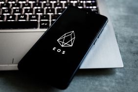 EOS cryptocurrency logo is displayed on a mobile phone screen photographed for illustration photo. 