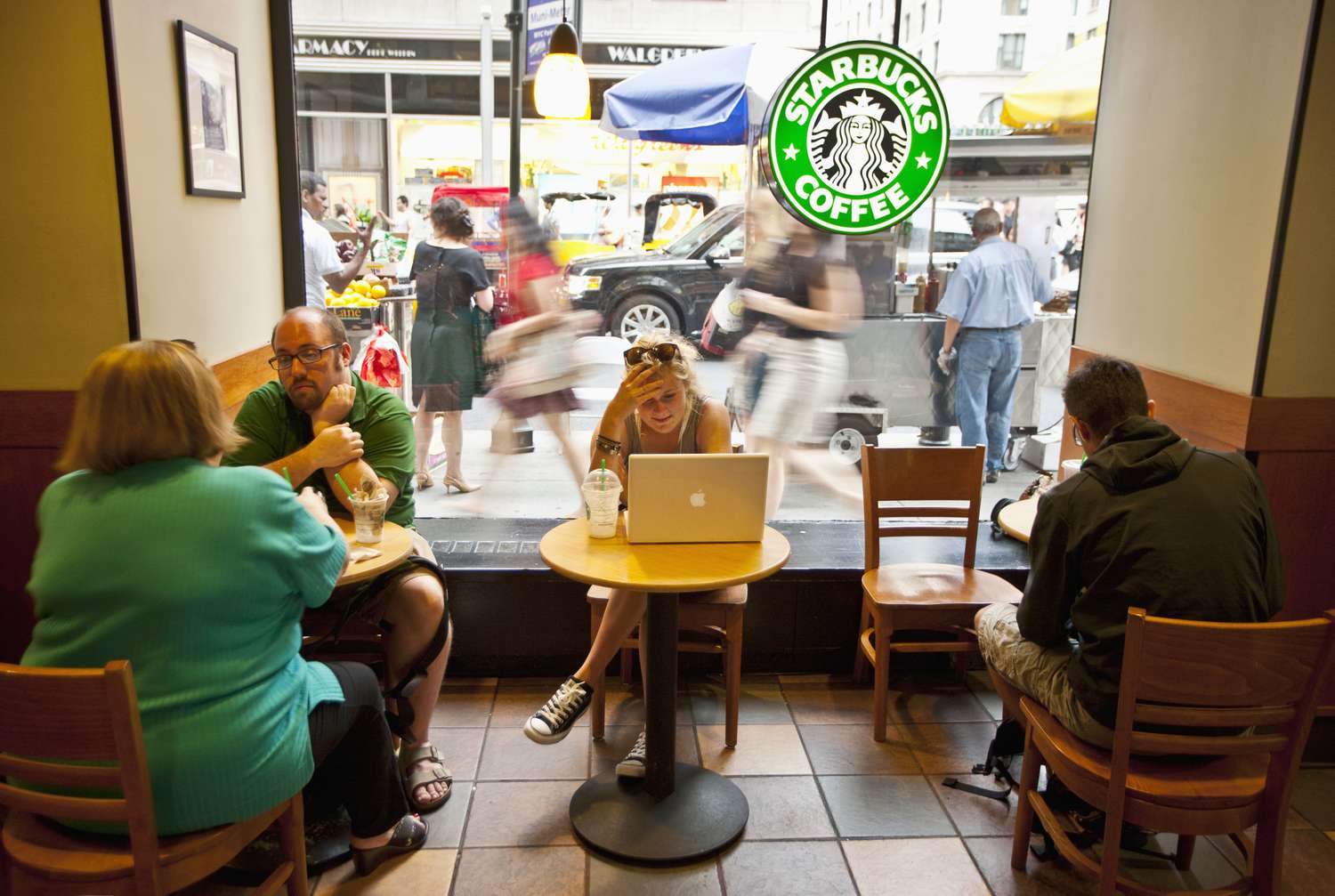 People sit at a Starbucks in New York. 