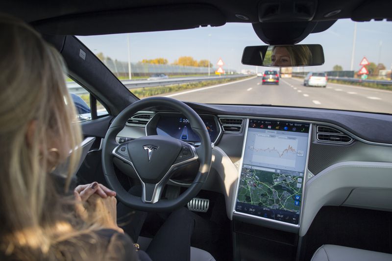 An employee drives a Tesla Motors Inc. Model S electric automobile, equipped with Autopilot hardware and software, hands-free on a highway in Amsterdam, Netherlands, on Monday, Oct. 26, 2015.