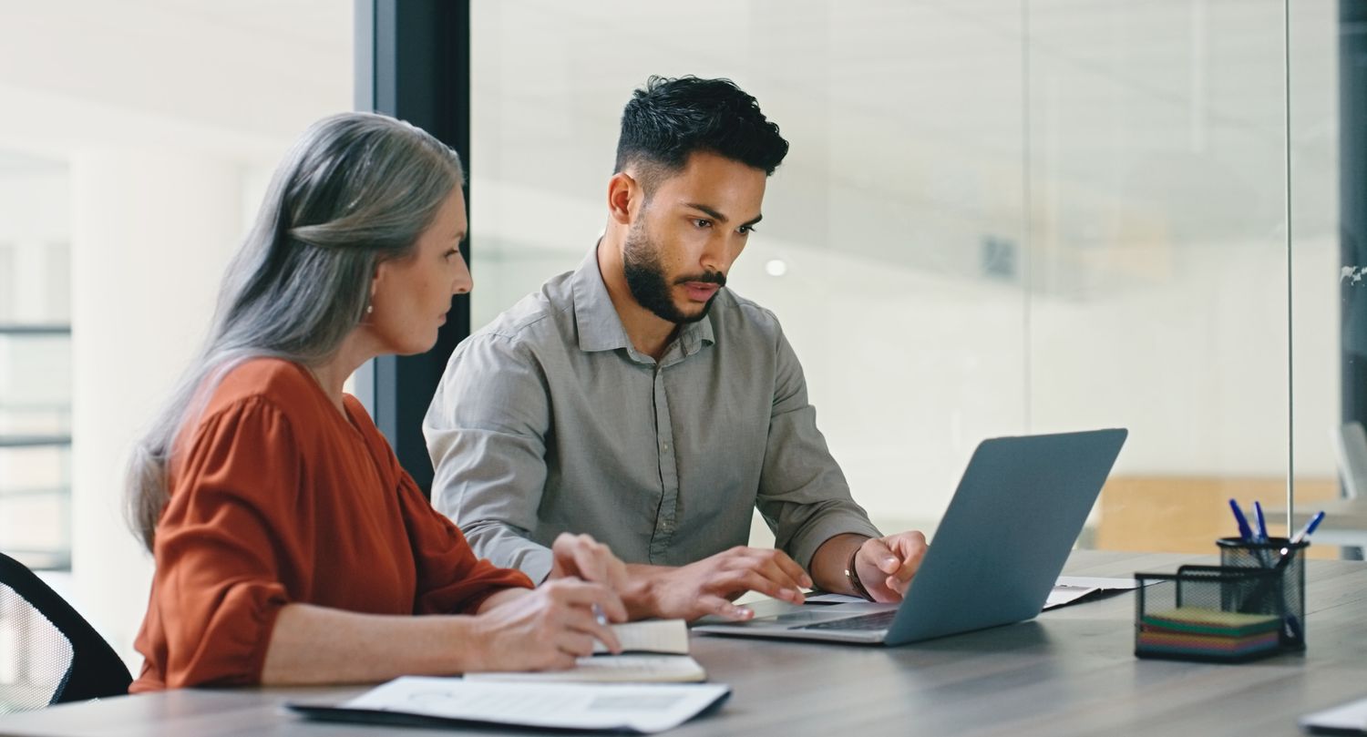 A client meets with an executive to review documents.