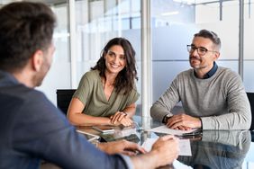 Mature couple meeting financial advisor about CD Rates