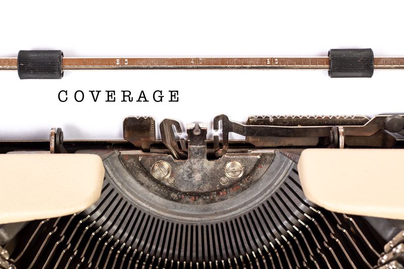 A typewriter with a typed page that says coverage