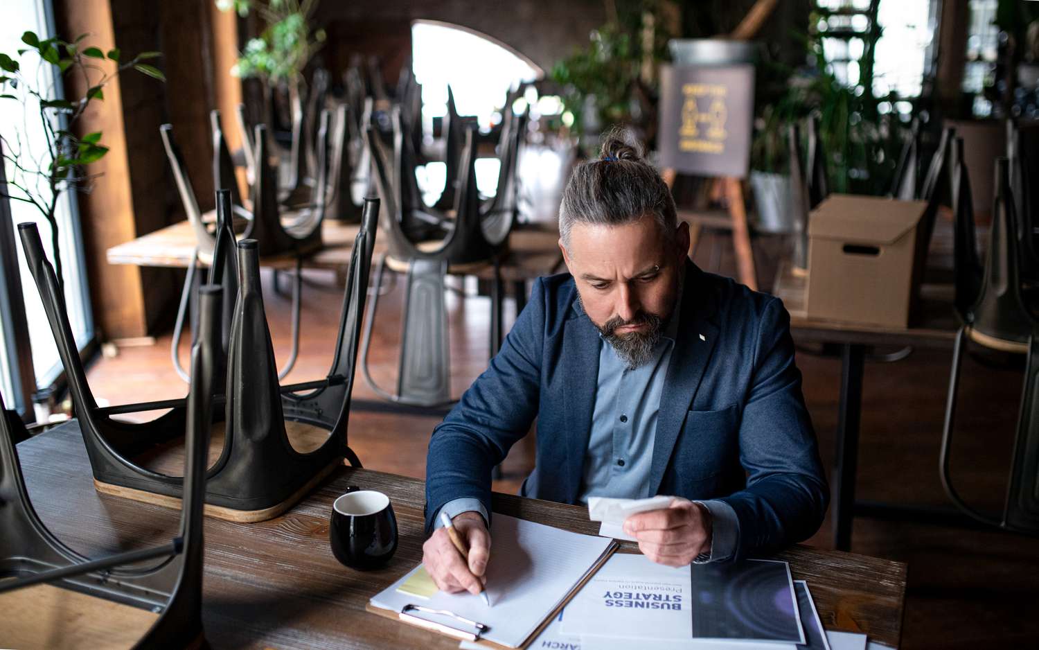 Restaurant owner working on paperwork at a table