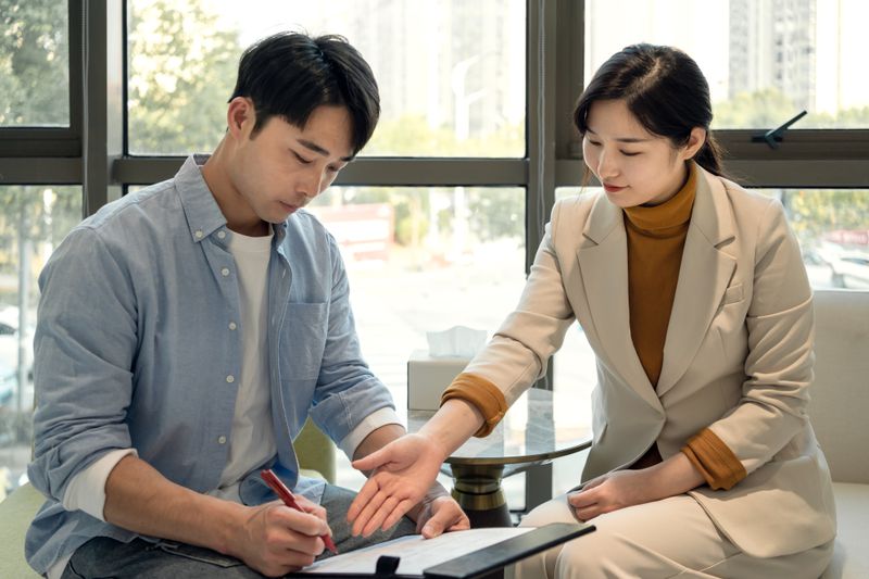 Business people negotiating and signing a business contract