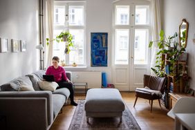 Homeowner sitting at home in the living and looking up home equity loan.
