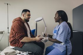 Patient talking to nurse about the expenses paid by health insurance.