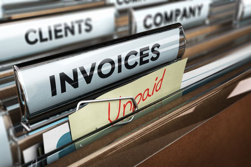 A file of invoices with an "unpaid" tab