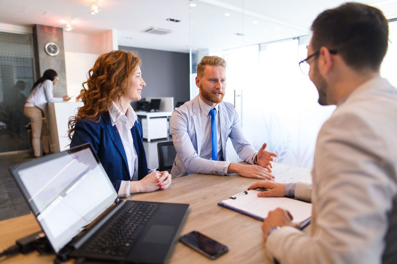 A financial advisor speaks with a couple