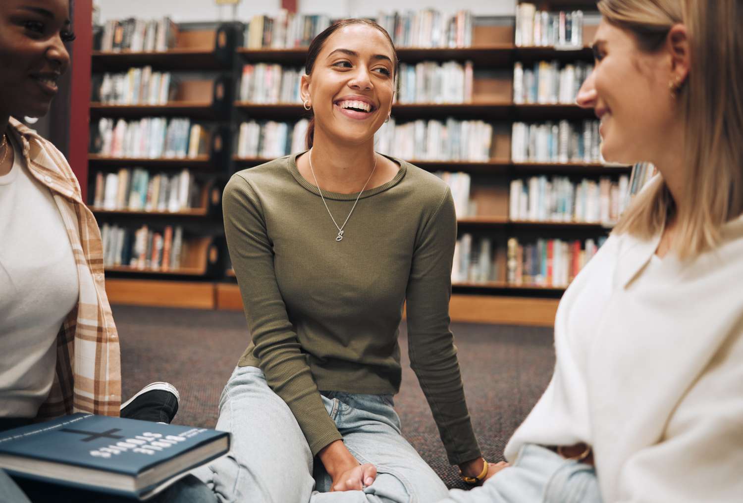 Friends have a book discussion in a local bookshop.