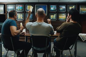 Three men in a betting shop with TVs showing various live betting events