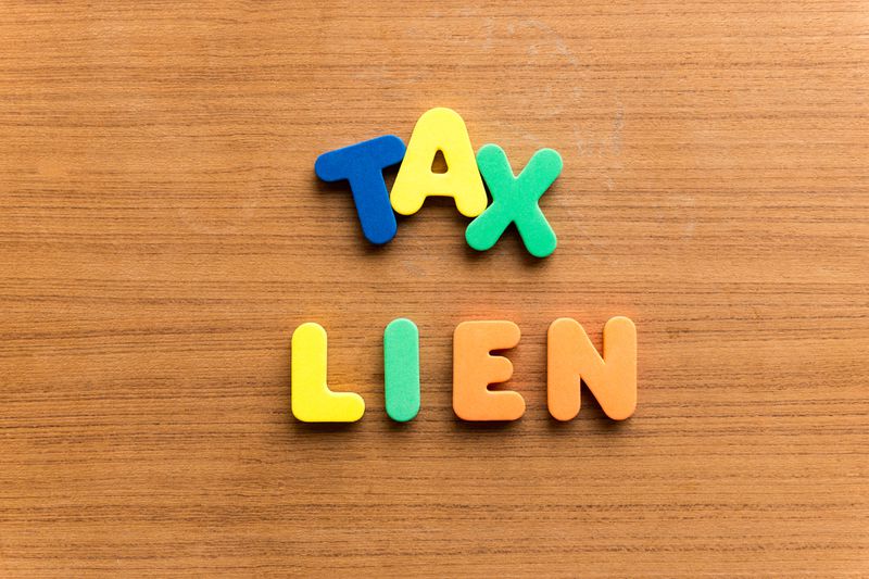 Words "tax lien" on wooden board