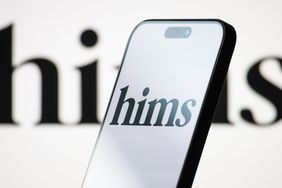 The logo of Hims & Hers Health, Inc. is displayed on a smartphone screen, with the company's minimalist branding visible in the background