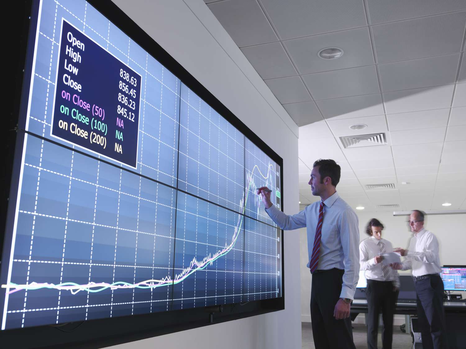 A person uses a screen pen to mark on a large screen.