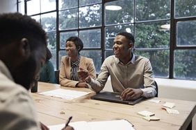 smiling colleagues in an conference room at a workplace