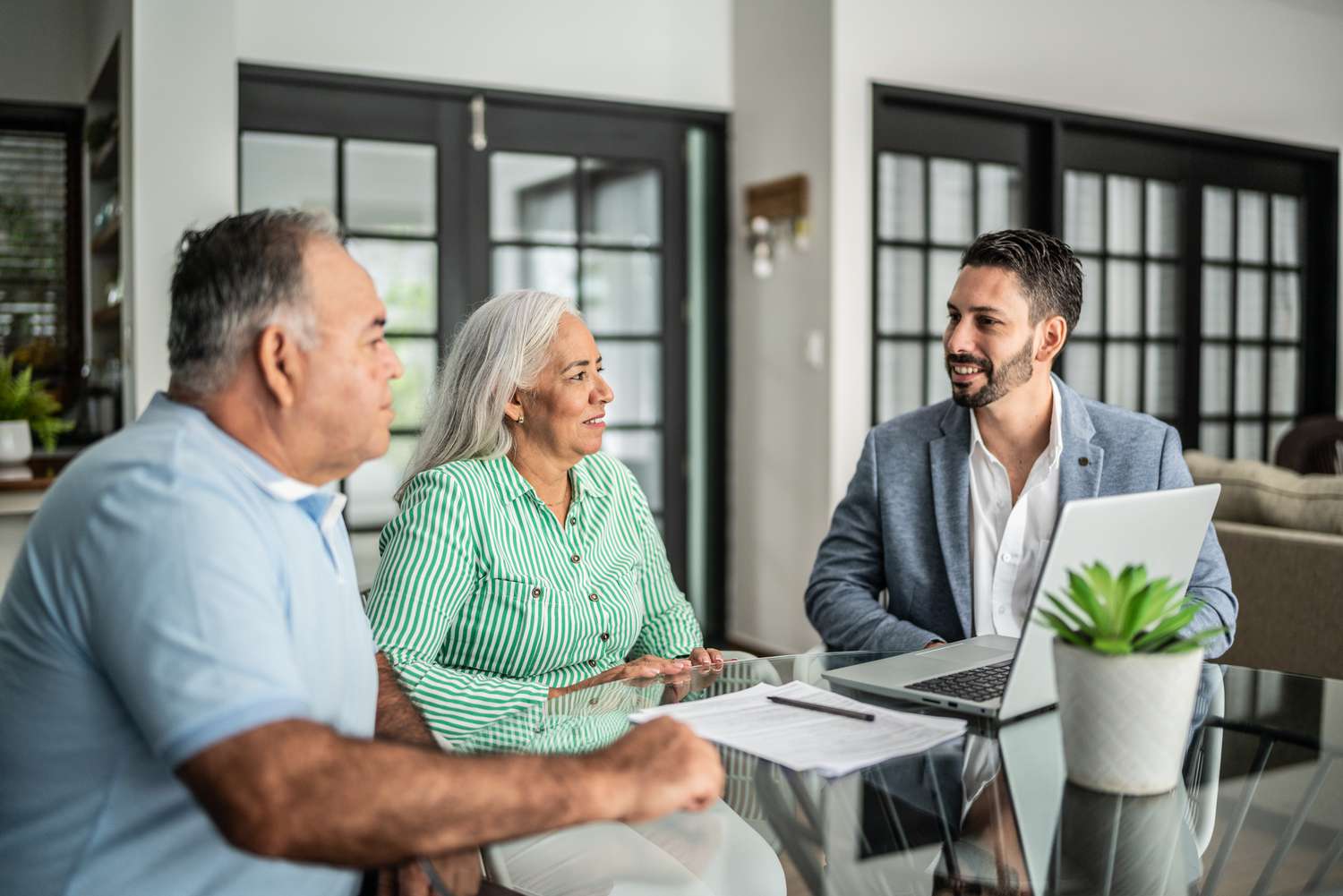 Couple talking with a financial advisor about risk-based mortgage pricing