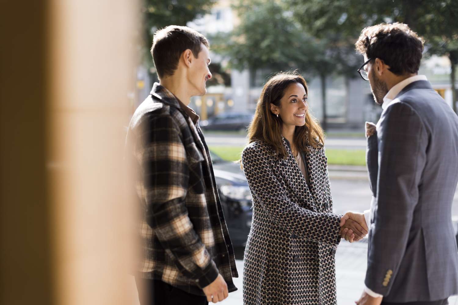 A real estate agent makes a sale outside of a home.