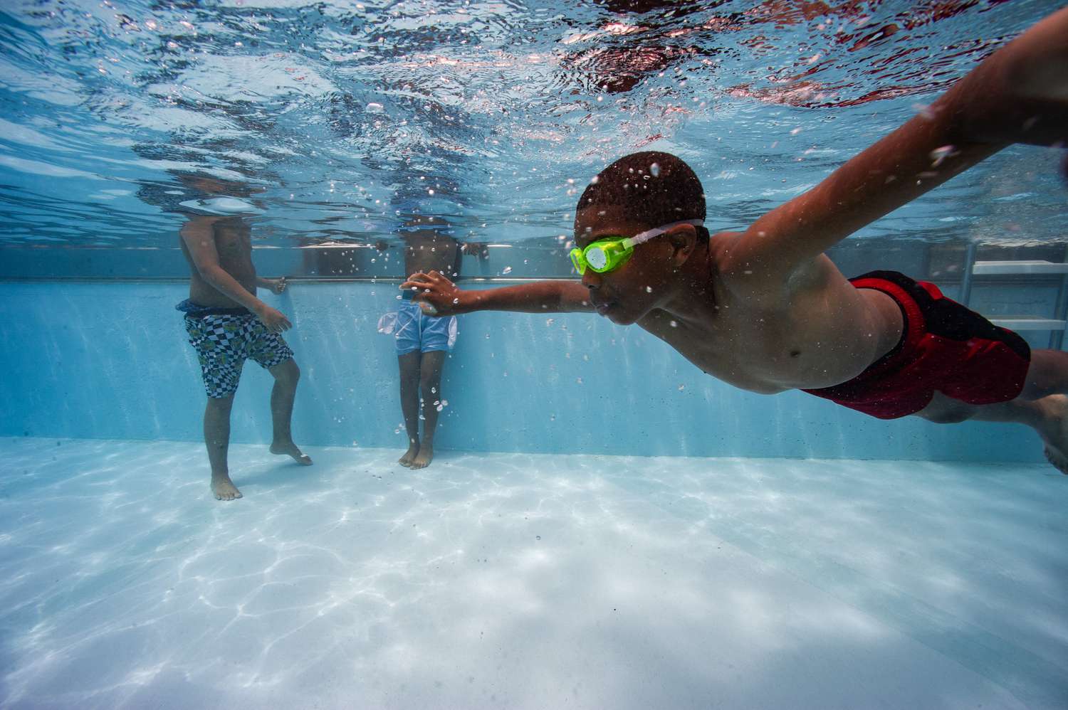 A child swims underwater at the Vietnam Veterans Memorial Pool in Chelsea, Massachusetts, on June 24, 2024