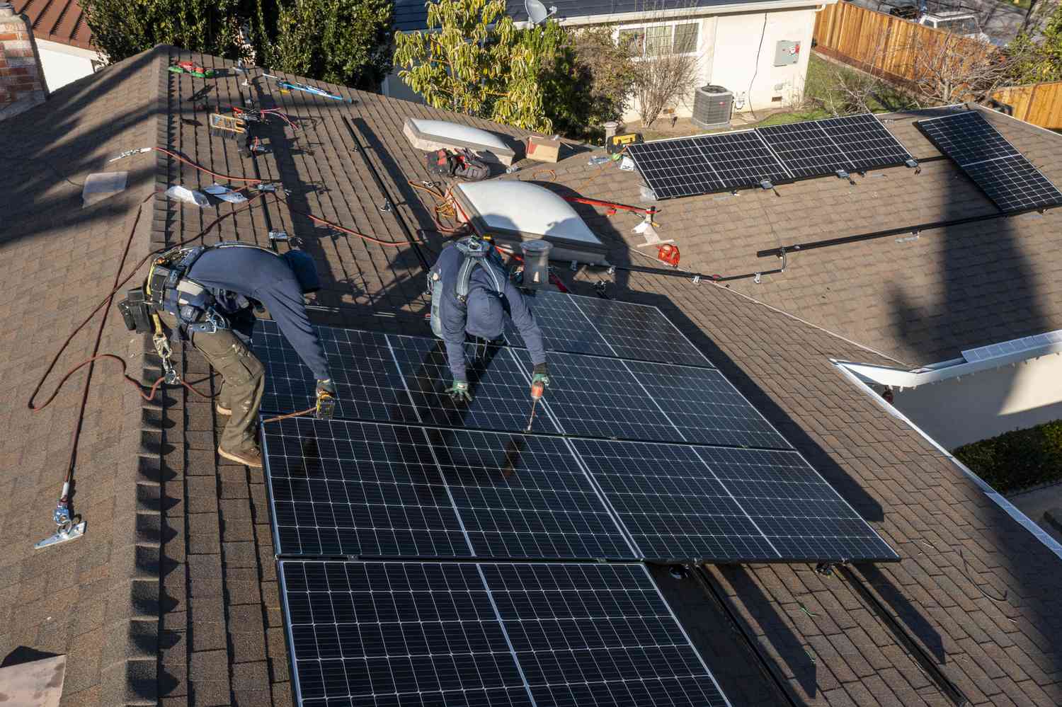 Contractors install SunRun solar panels on the roof of a home in San Jose, California, U.S., on Monday, Feb. 7, 2022. 