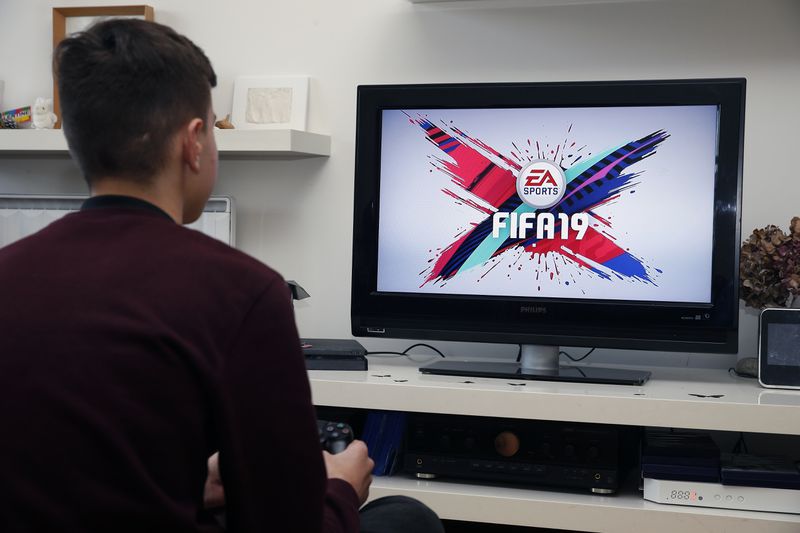 boy playing EA video game