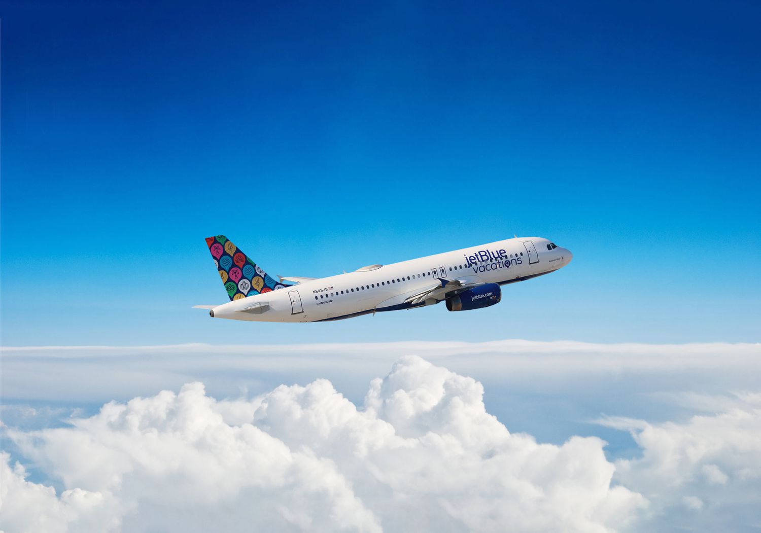 Photo of JetBlue Vacations airplane in the sky over clouds
