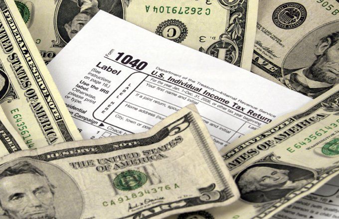 1040 form surrounded by dollar bills