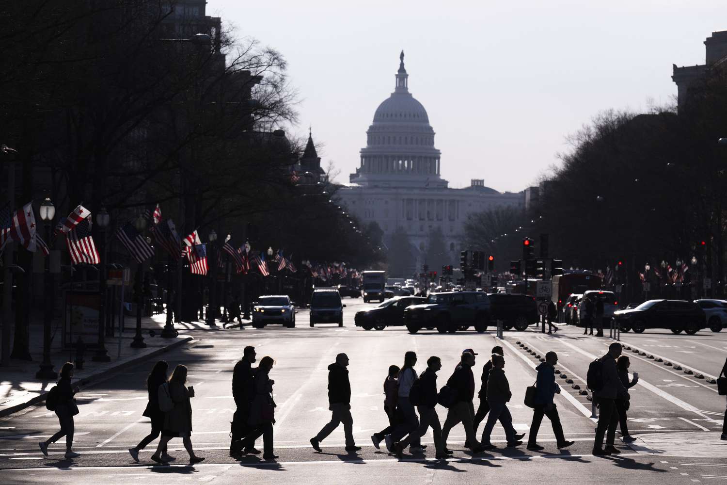 Commuters cross Pennsylvania Avenue in downtown Washington, DC
