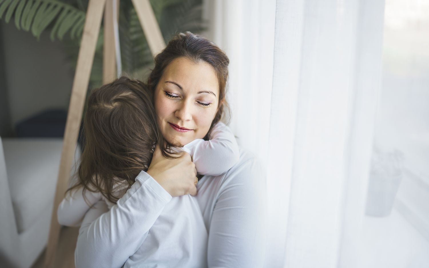 Mother hugging child