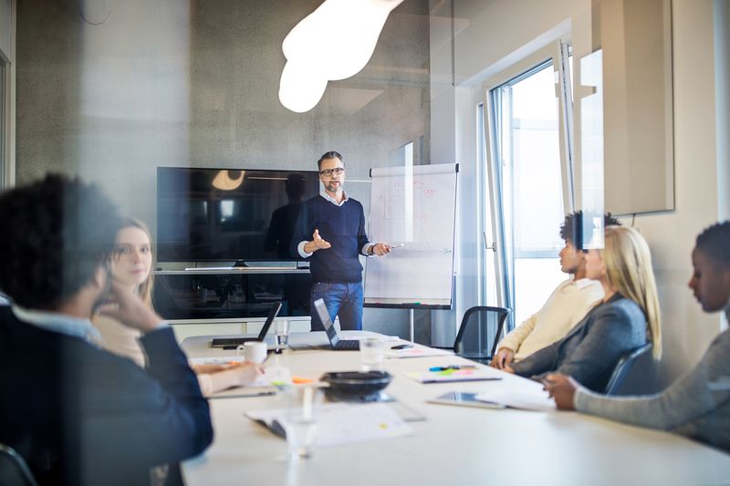 Group of People During a Presentation in Modern Office