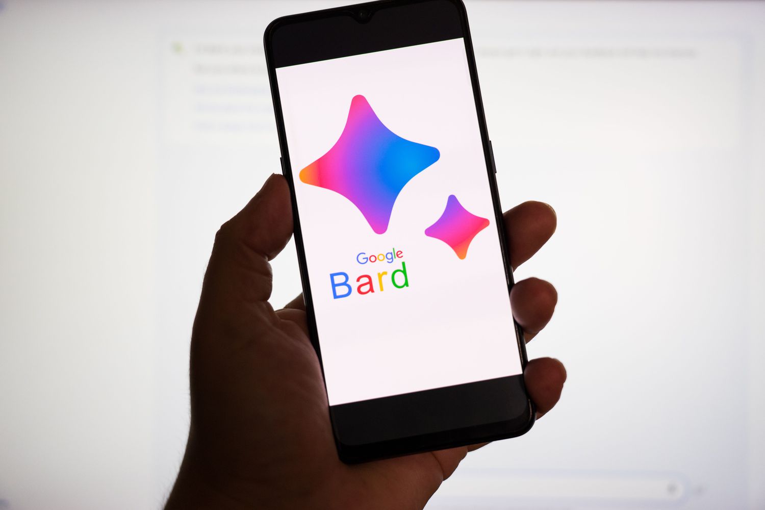 Hand holding a smartphone with the Google Bard logo on screenn