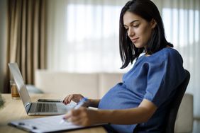 Pregnant woman working from home