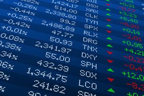 The New York Stock Exchange board, controlled by a stock watcher digital software, displays stock price and volume data.