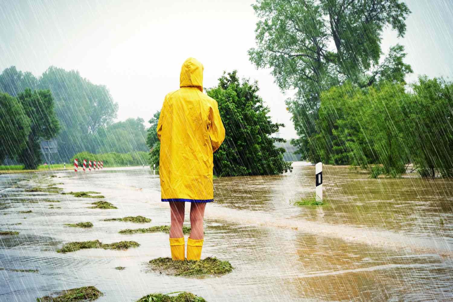 Woman standing in a flooded street.
