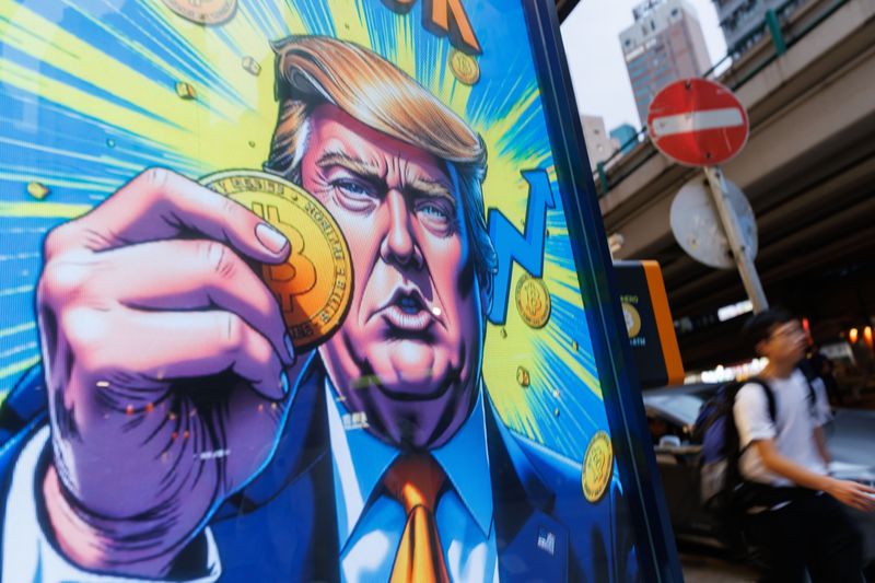 People walk past an advertisement featuring Donald Trump with Bitcoin in Hong Kong.